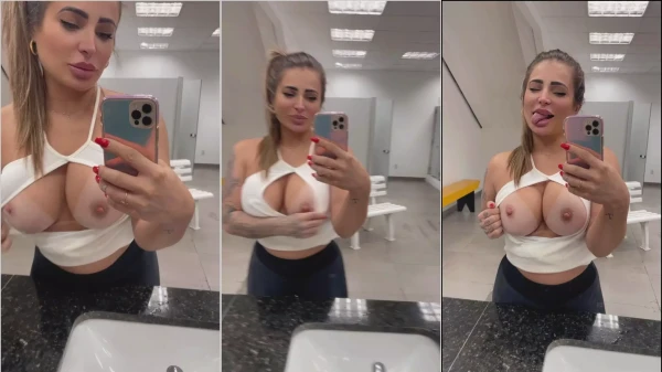 Kelly Valim in the gym mirror showing the big tits